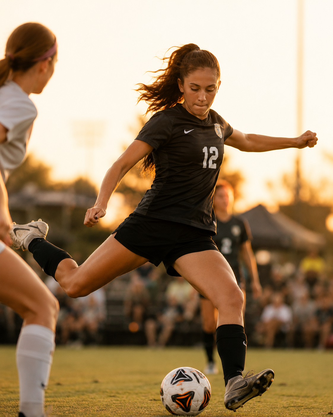 Teen soccer player mid-strike at golden hour during a tournament game
