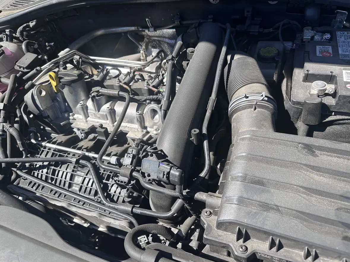 A real photograph taken in the shop: an engine bay open, mid-job.
